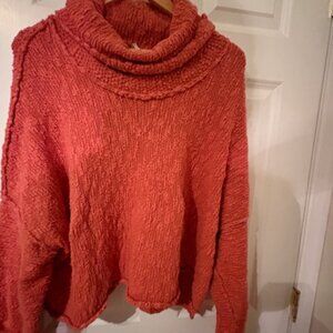 Free People cozy, plush chenille-style sweater in a rich coral-rose co